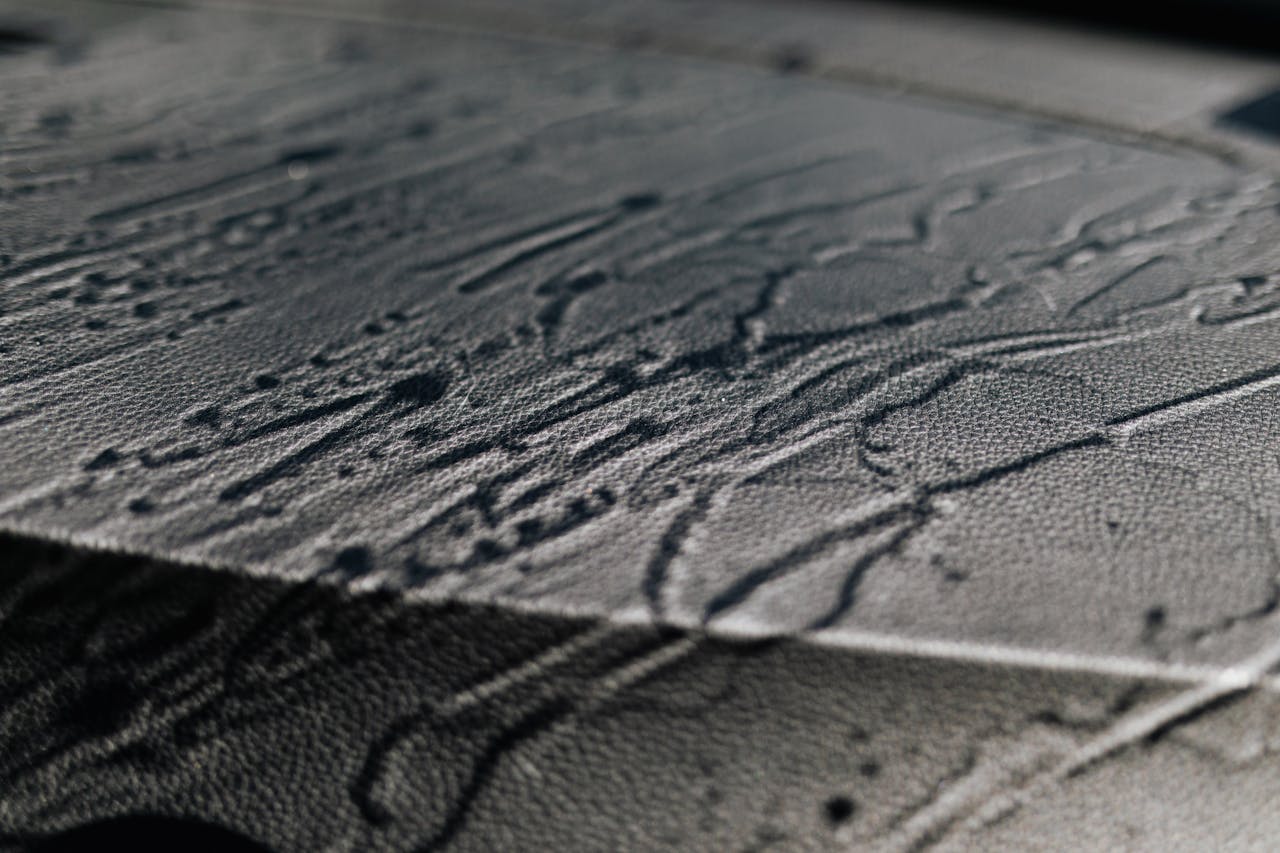 Extreme close-up of textured leather with shadows and intricate patterns.